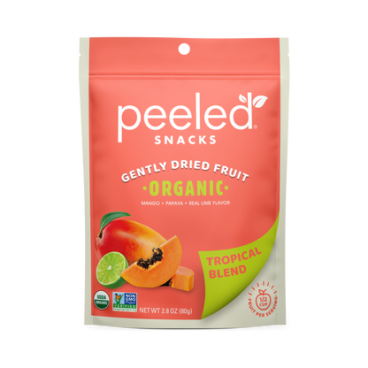 Peeled Snacks Gently Dried Fruit Organic Tropical Blend packaging, featuring a vibrant coral pink and lime green design, illustrations of fresh mango papaya and lime, and USDA Organic and Non-GMO Project Verified seals